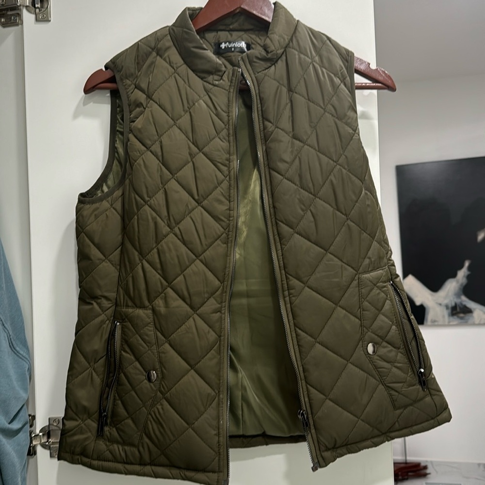 Worn maybe once.  Green quilted vest.  NOT CROPPED.